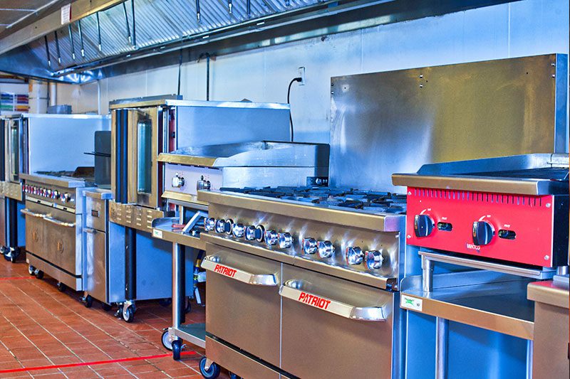 A kitchen with many different types of appliances.