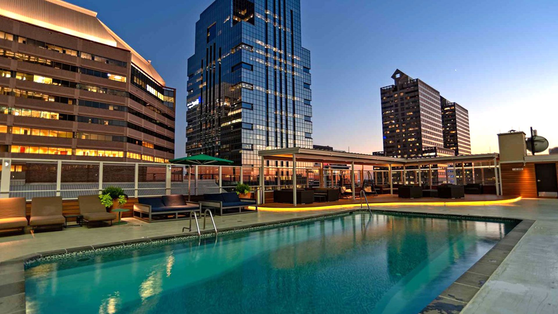 A pool with chairs and tables in the middle of it